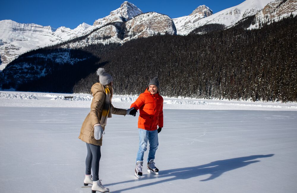 A couple skating on Lake Louise in the winter in Banff National Park